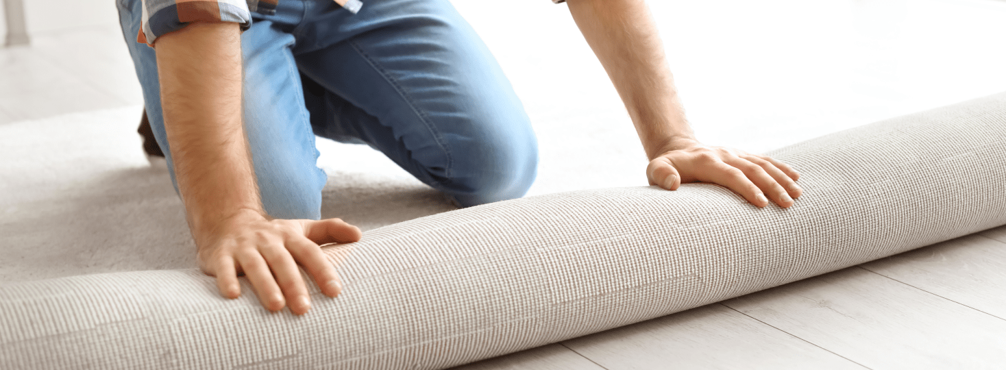 Man installing white carpet flooring 