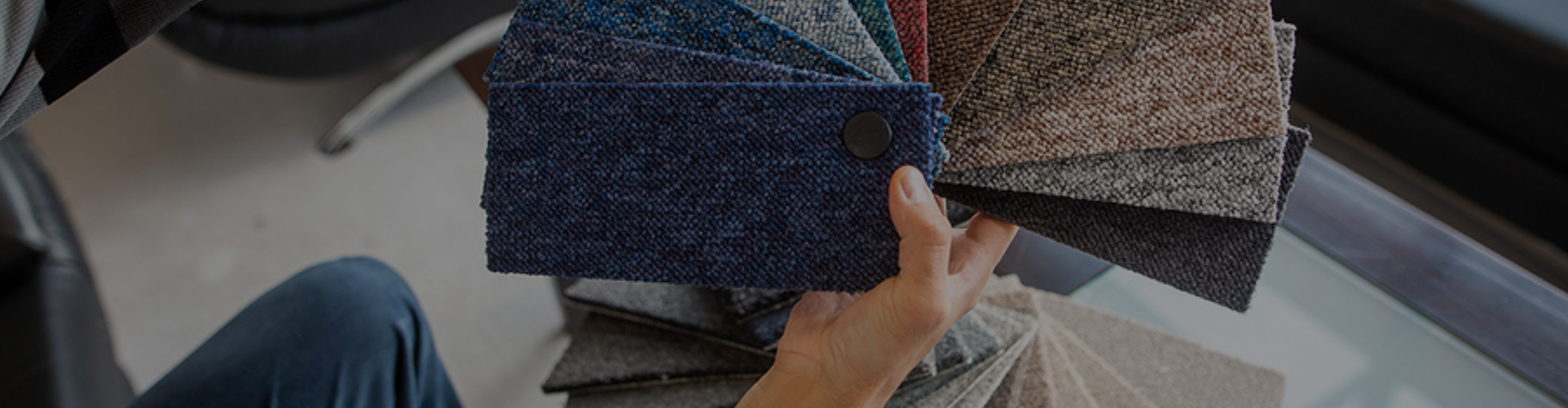 Colorful carpet samples with hands. 