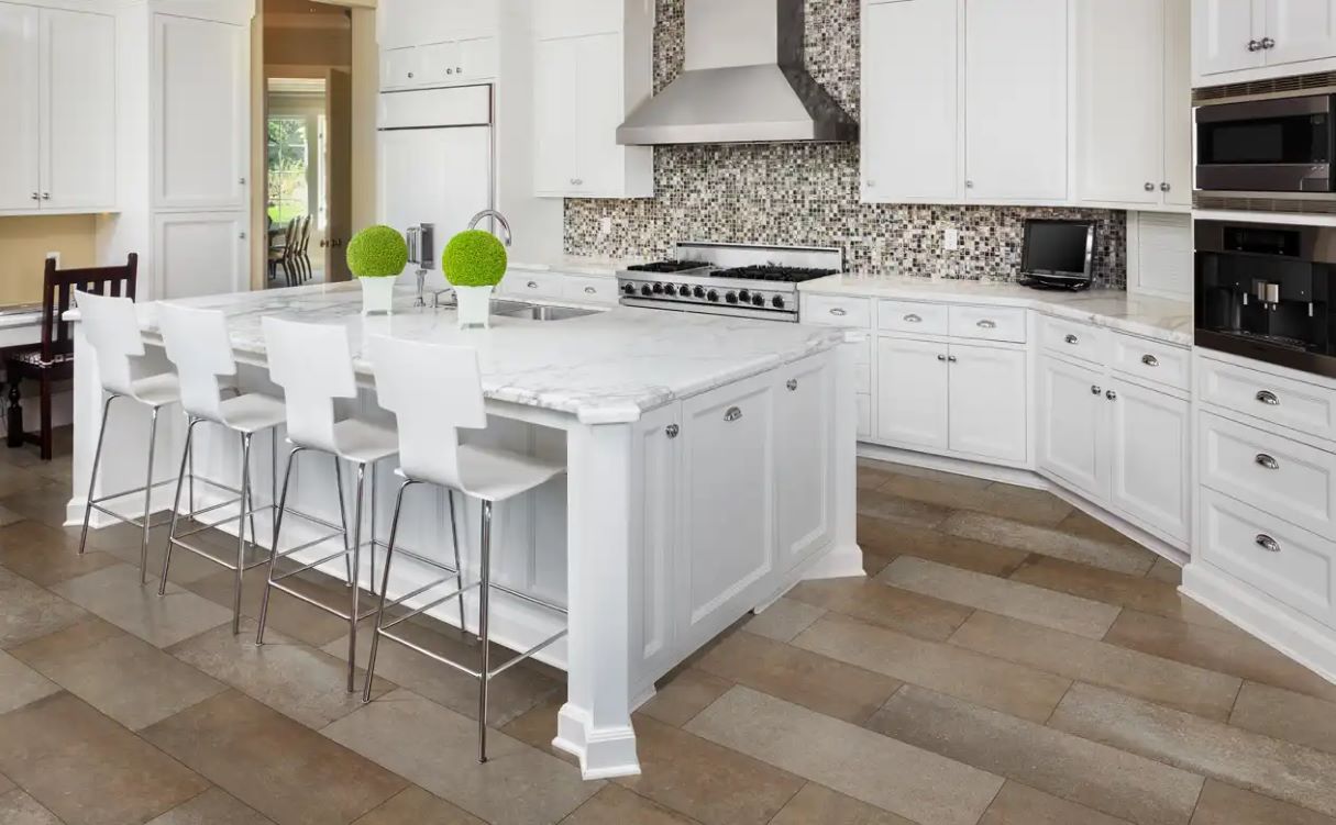 White quartz counter with island seating. 