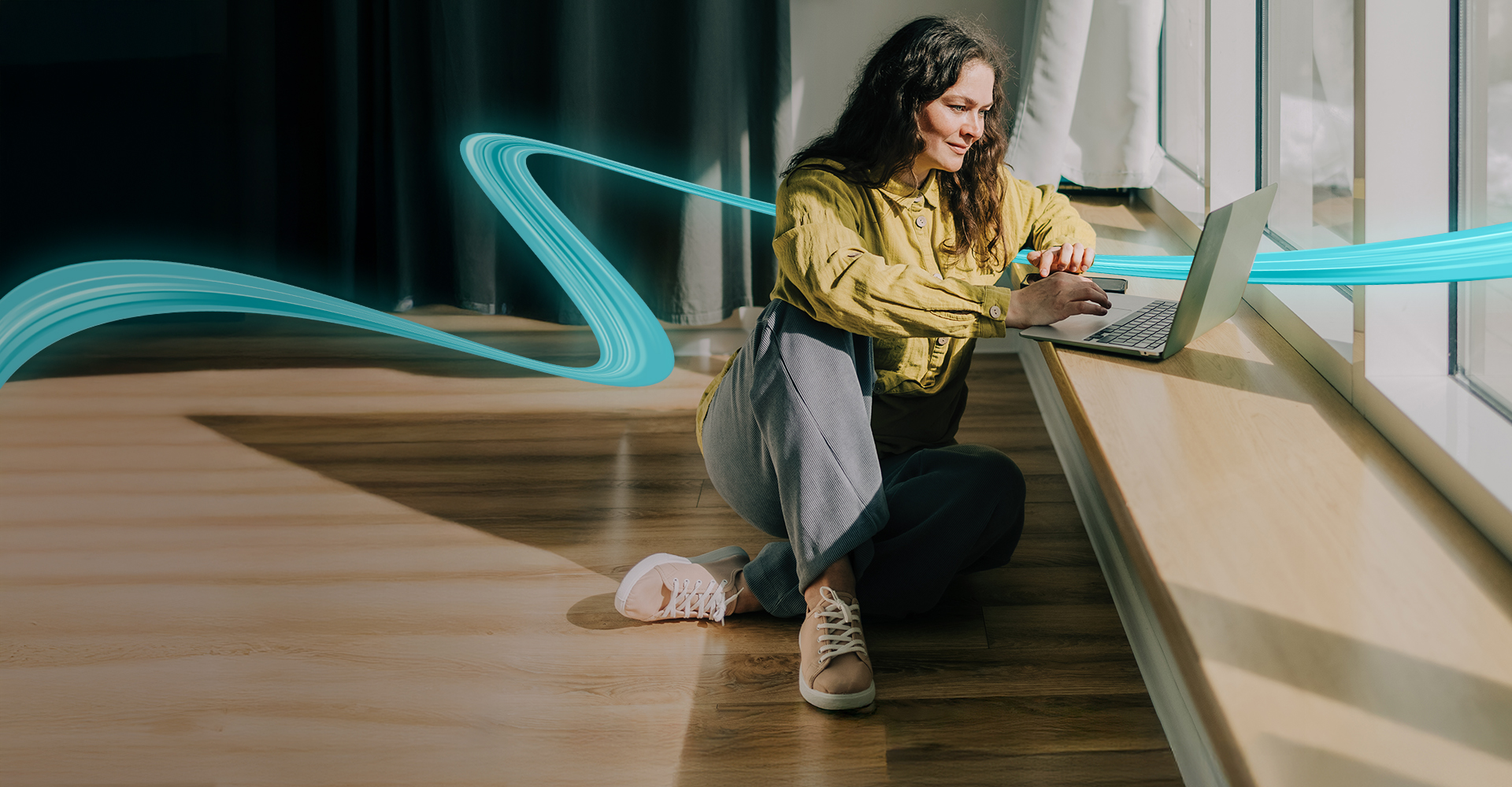Woman sitting on a hardwood floor with a coffee mug in her hand.
