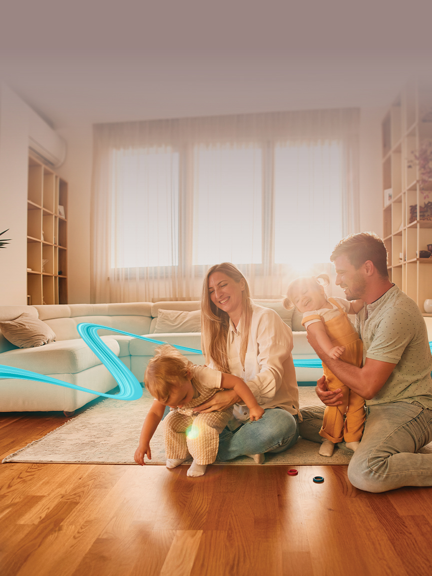 Woman sitting on a hardwood floor with a coffee mug in her hand.