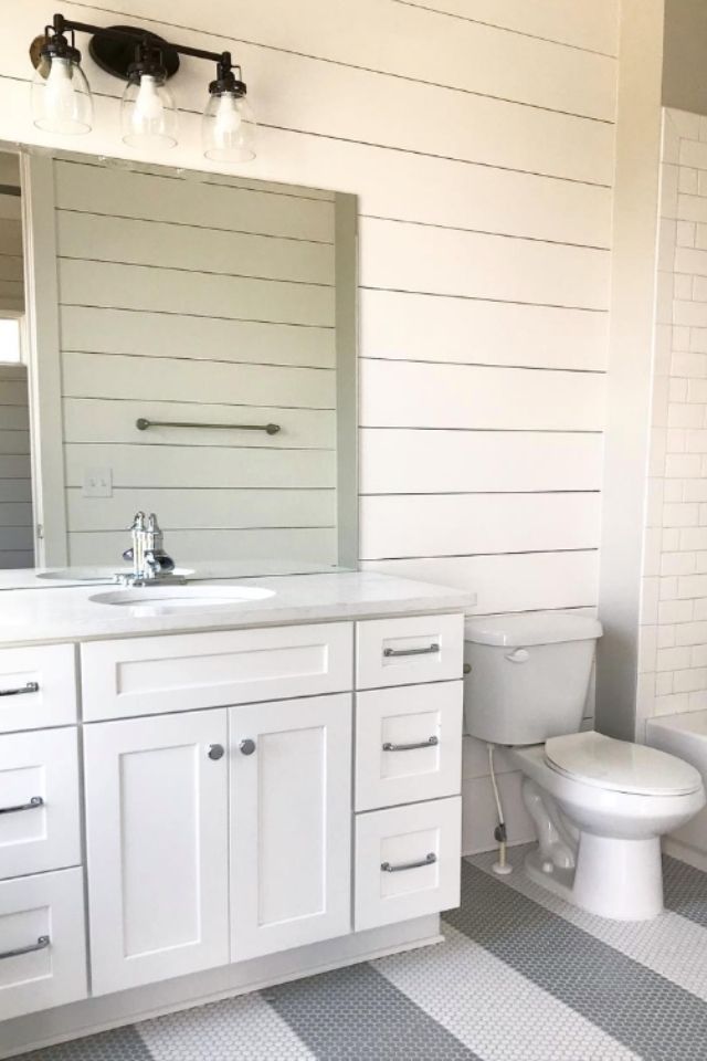 Shiplap bathroom with white and black tile 