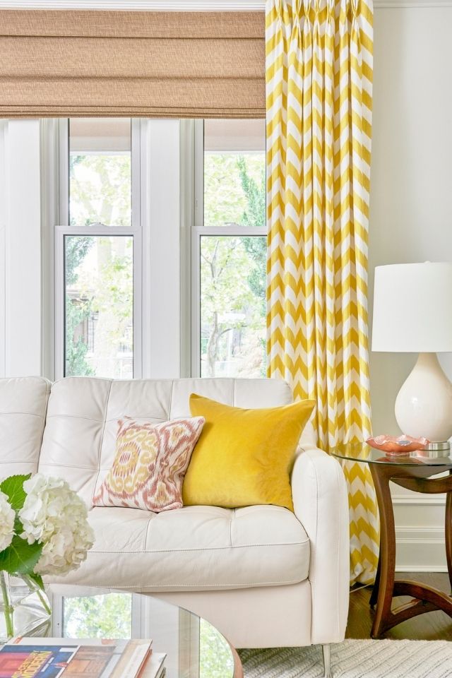 Yellow patterned curtains in living room with new furniture 