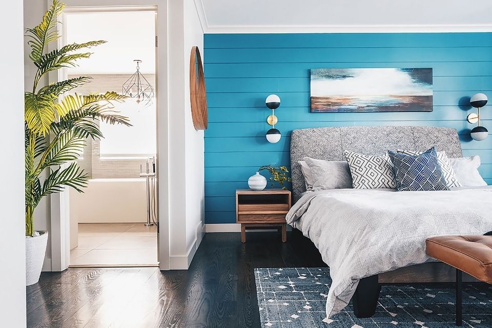 Bright blue wall in bedroom designed by Louis Duncan-He