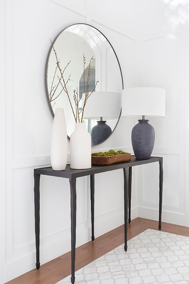 Tile inlay in entryway with mirror and table