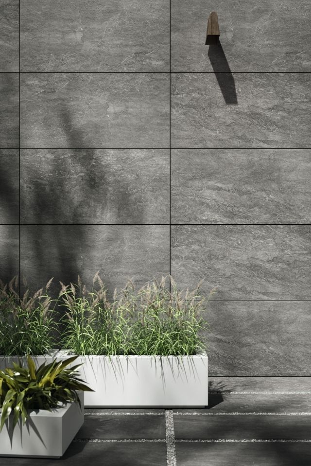 Large-format dark gray wall tile in outdoor space by Daltile