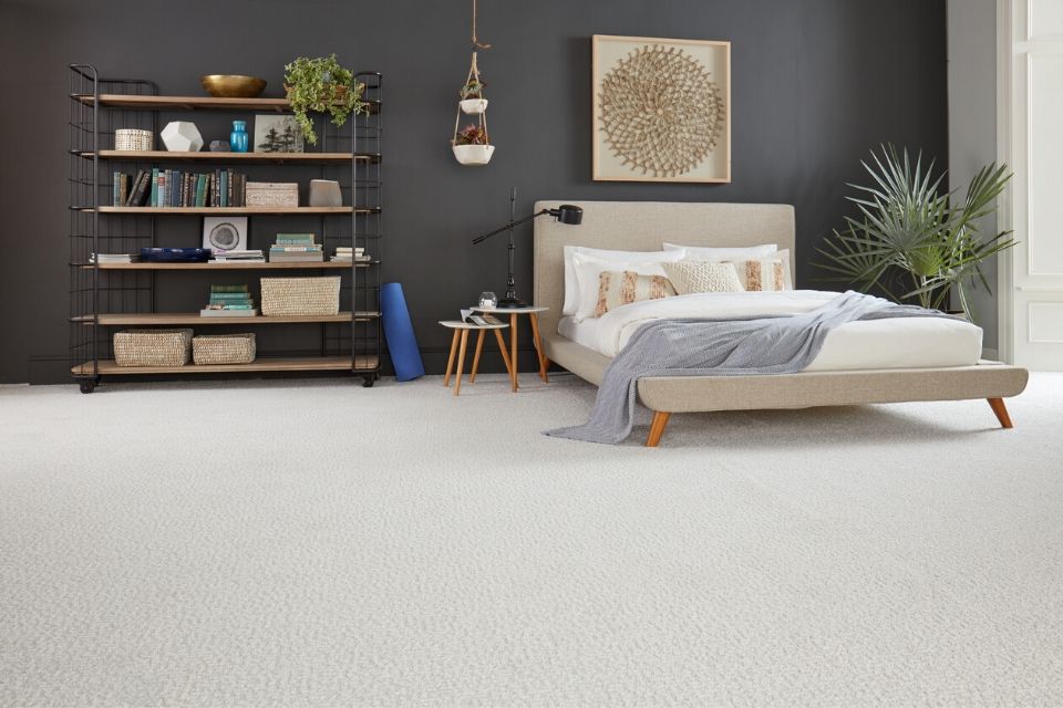 Beige living room carpet in bedroom with dark gray walls 