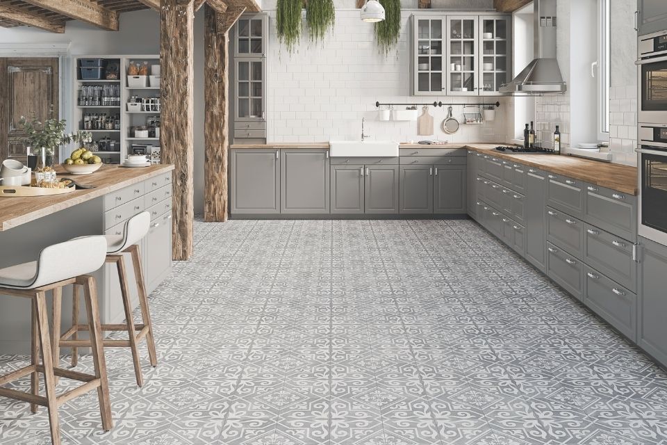 Gray patterned floor tile in large farmhouse style kitchen 