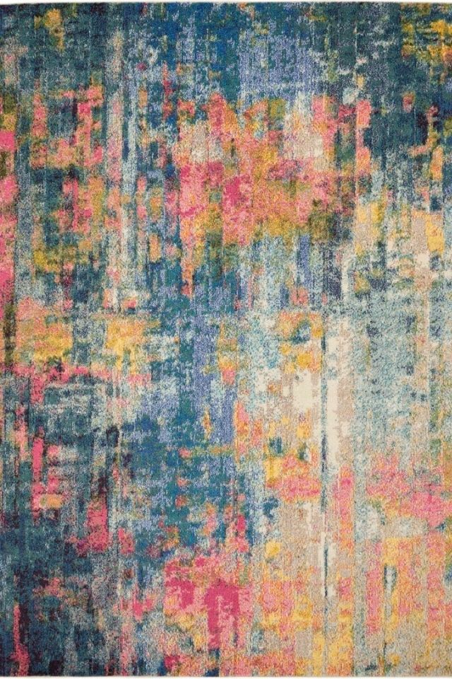 Abstract looking area rug by Nourison with blue, pink, and beige 