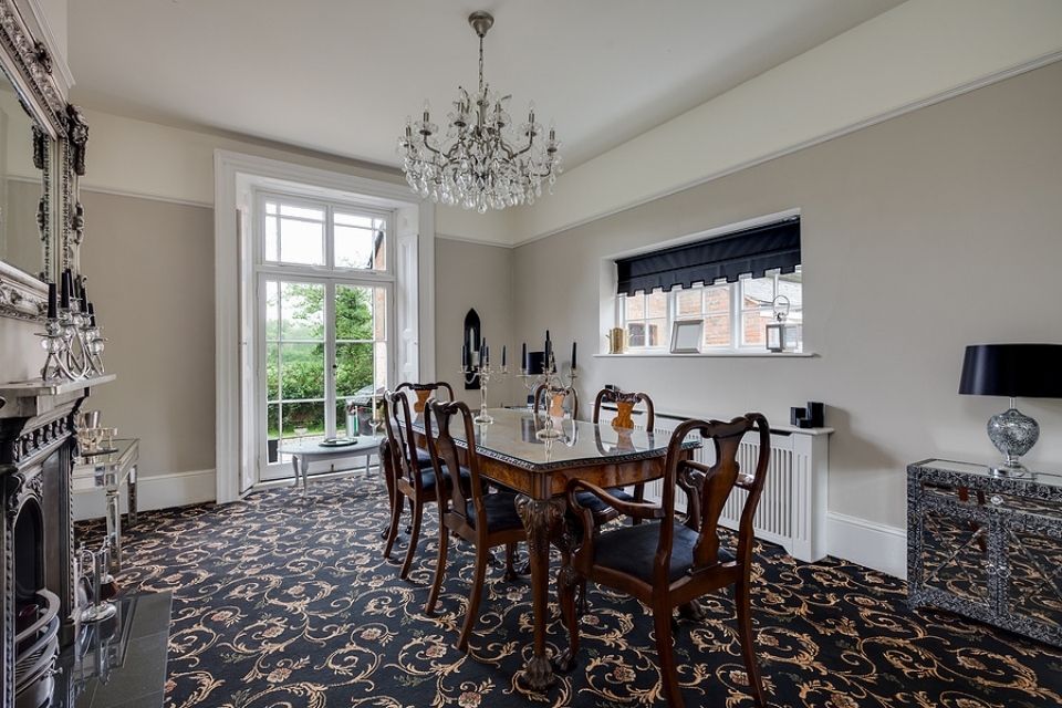 traditional dining room with elegant patterned carpet