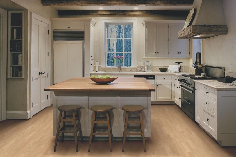 Oak hardwood floor in kitchen with island seating 