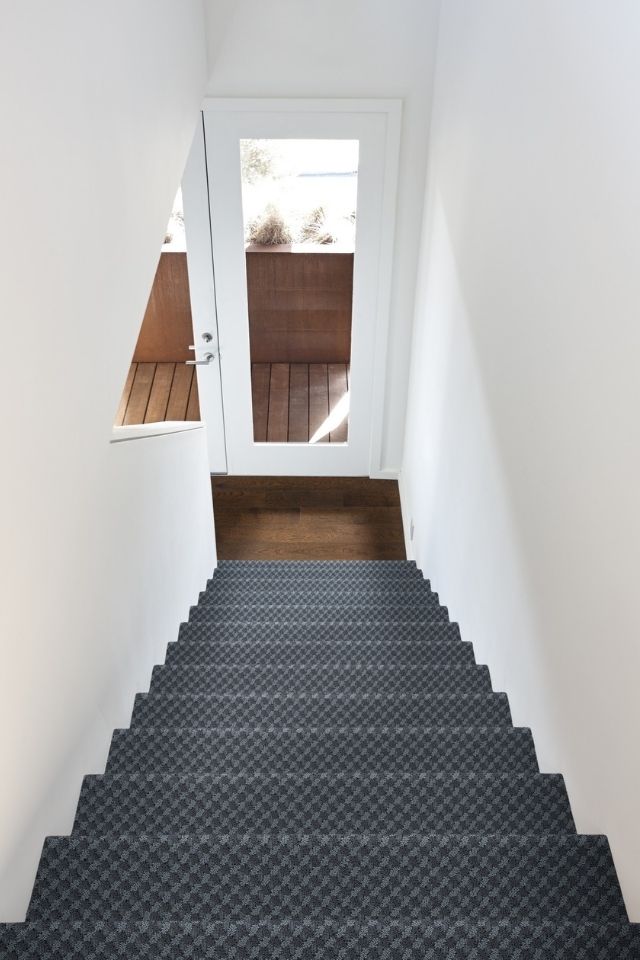 stairway with patterned wall-to-wall carpet