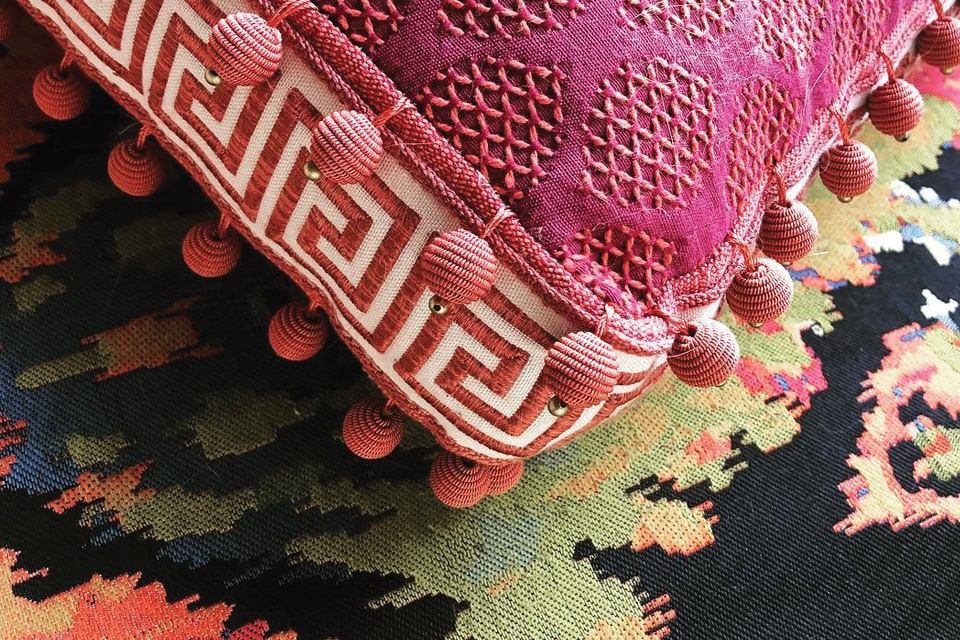 Pink patterned fabric and tassels on pillow