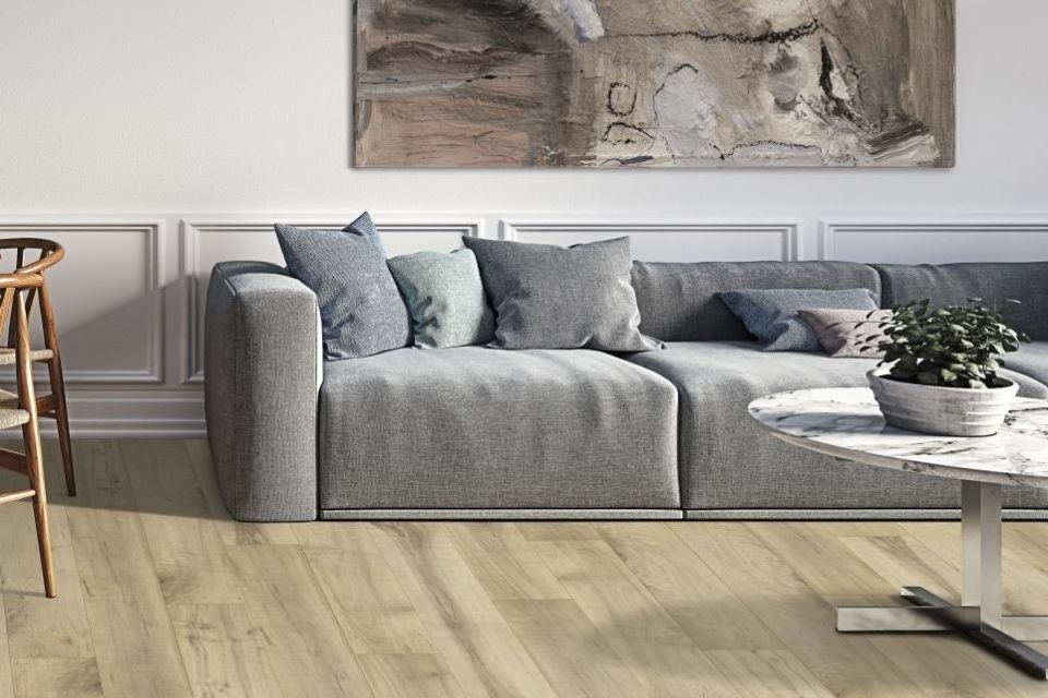 Light colored wood look laminate in living room with gray couch 