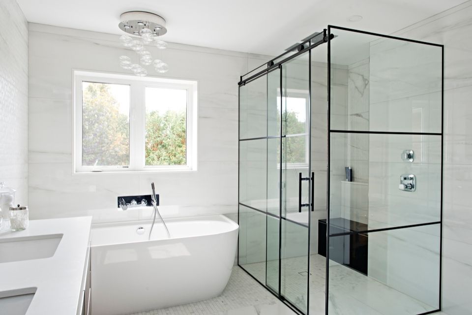 large walk in shower in Black and white bathroom with soaking tub 