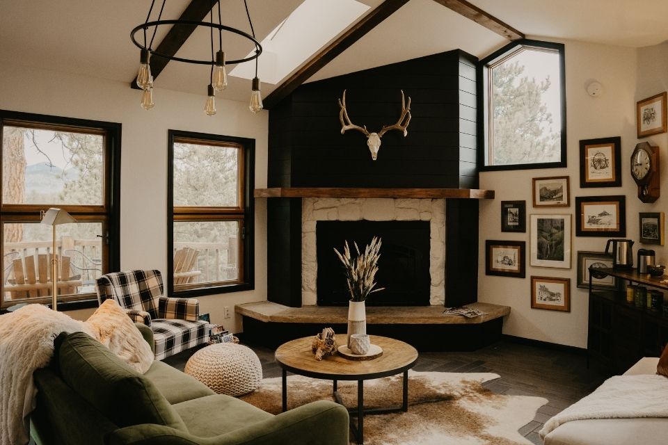 Modern cabin design with black shiplap on fireplace in living room 
