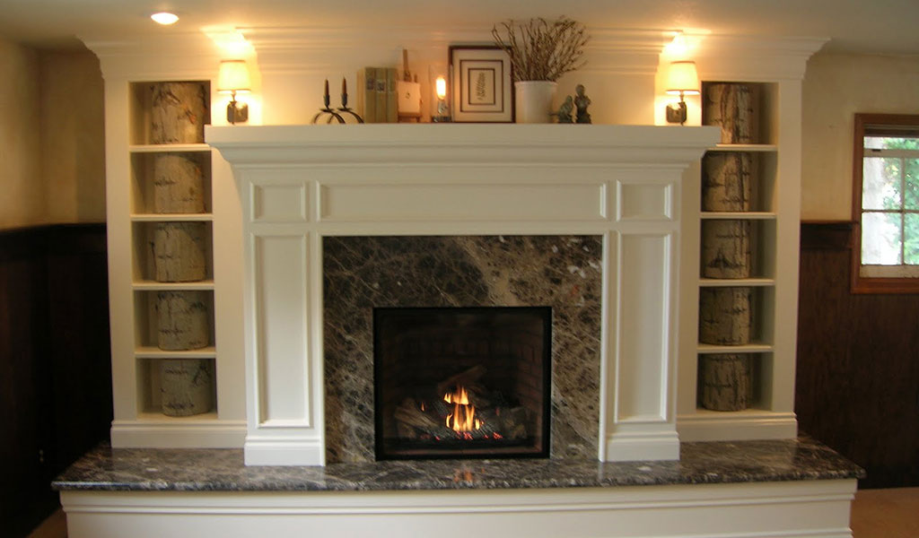 cozy fireplace with marble surround by Jared Rohrer Design