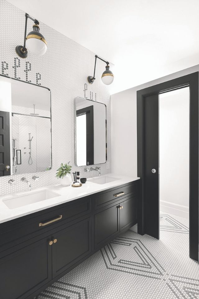 Beautiful black and white custom bathroom with black accents on tile flooring 