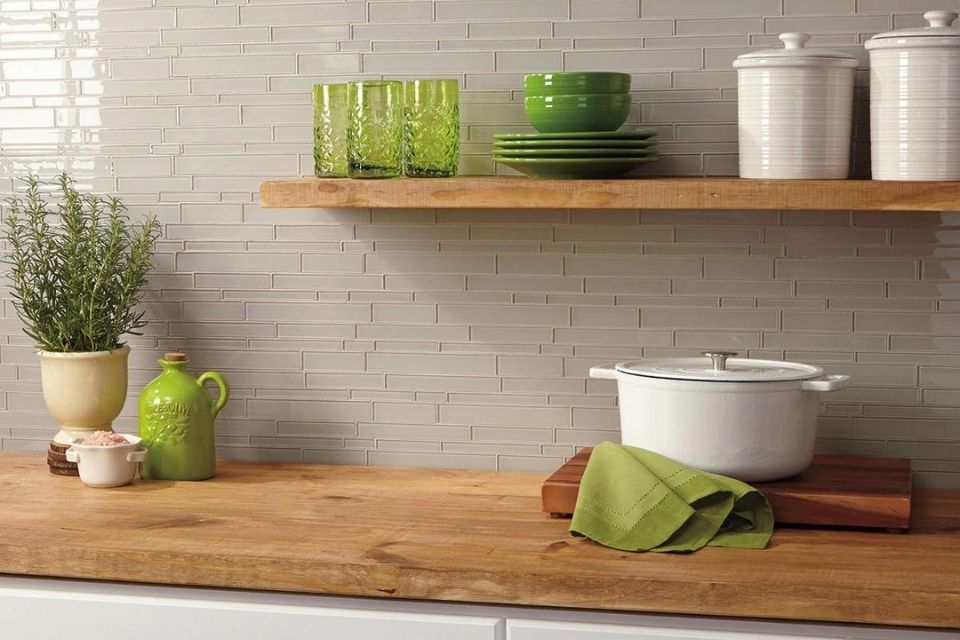 white glass subway tile backsplash in kitchen with green accents | amity by Daltile
