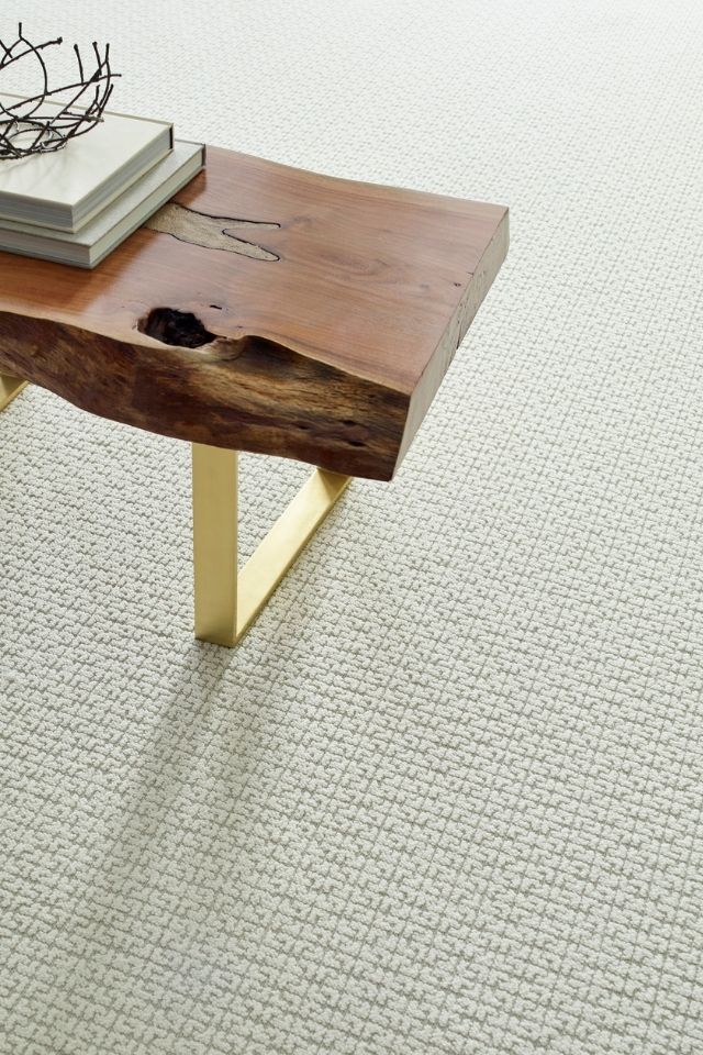 geometric patterned carpet underneath rustic table