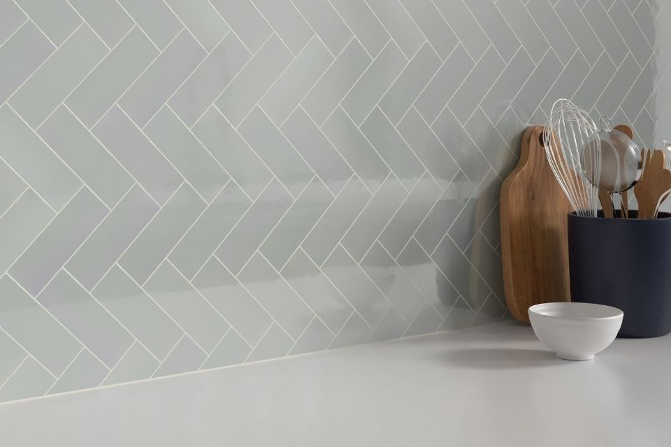 gray rectangular backsplash tile in herringbone pattern