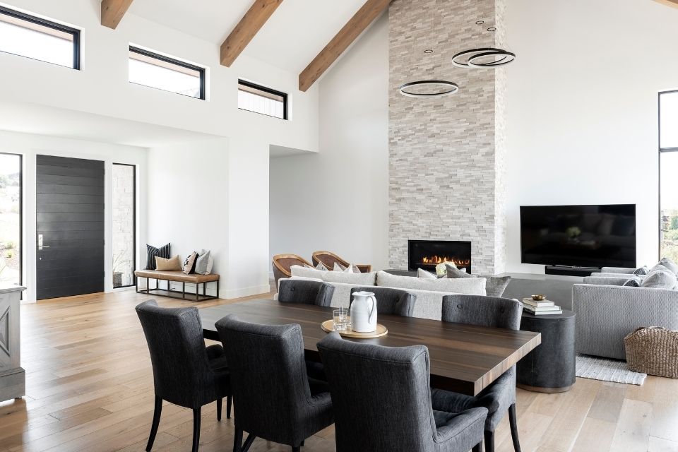 Modern farmhouse design by Christa Pirl with large stone fireplace and high ceilings 