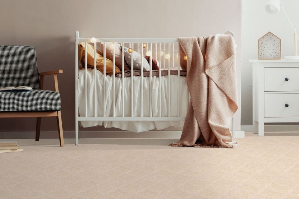 soft beige carpet in nursery with white crib