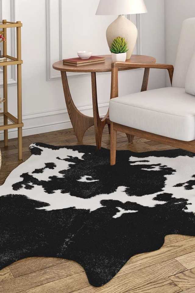 small cow print area rug in living room corner