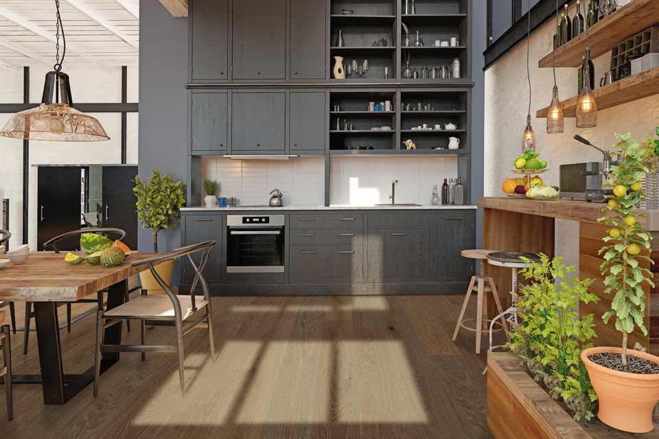 natural hardwood flooring in kitchen with gray cabinetry, open wood shelving, and greenery 