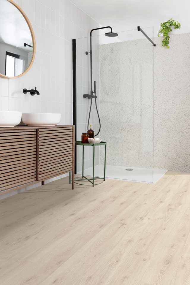 light white oak look laminate in modern bathroom with shower tile and greenery
