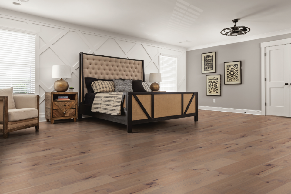 Bedroom with natural-toned hardwood