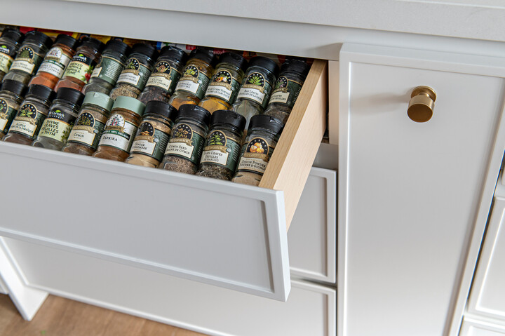 Spice drawer filled with bottles of spices.