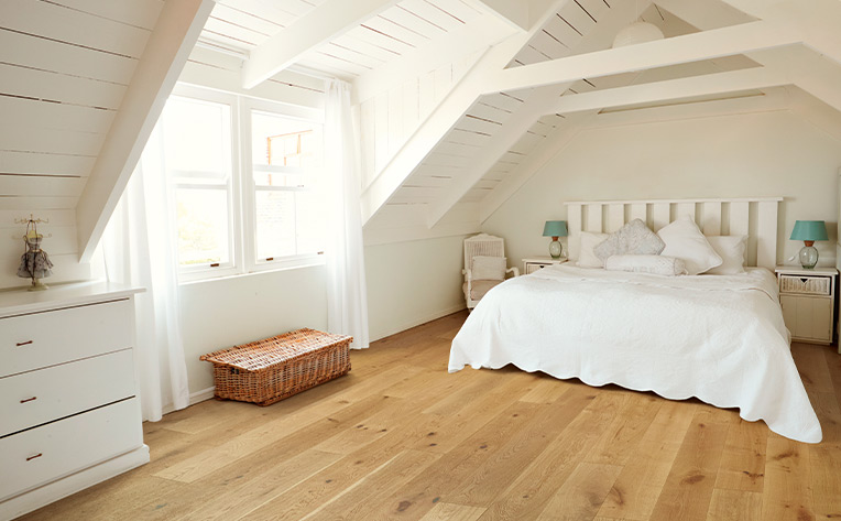 beach house flooring warm toned in attic bedroom